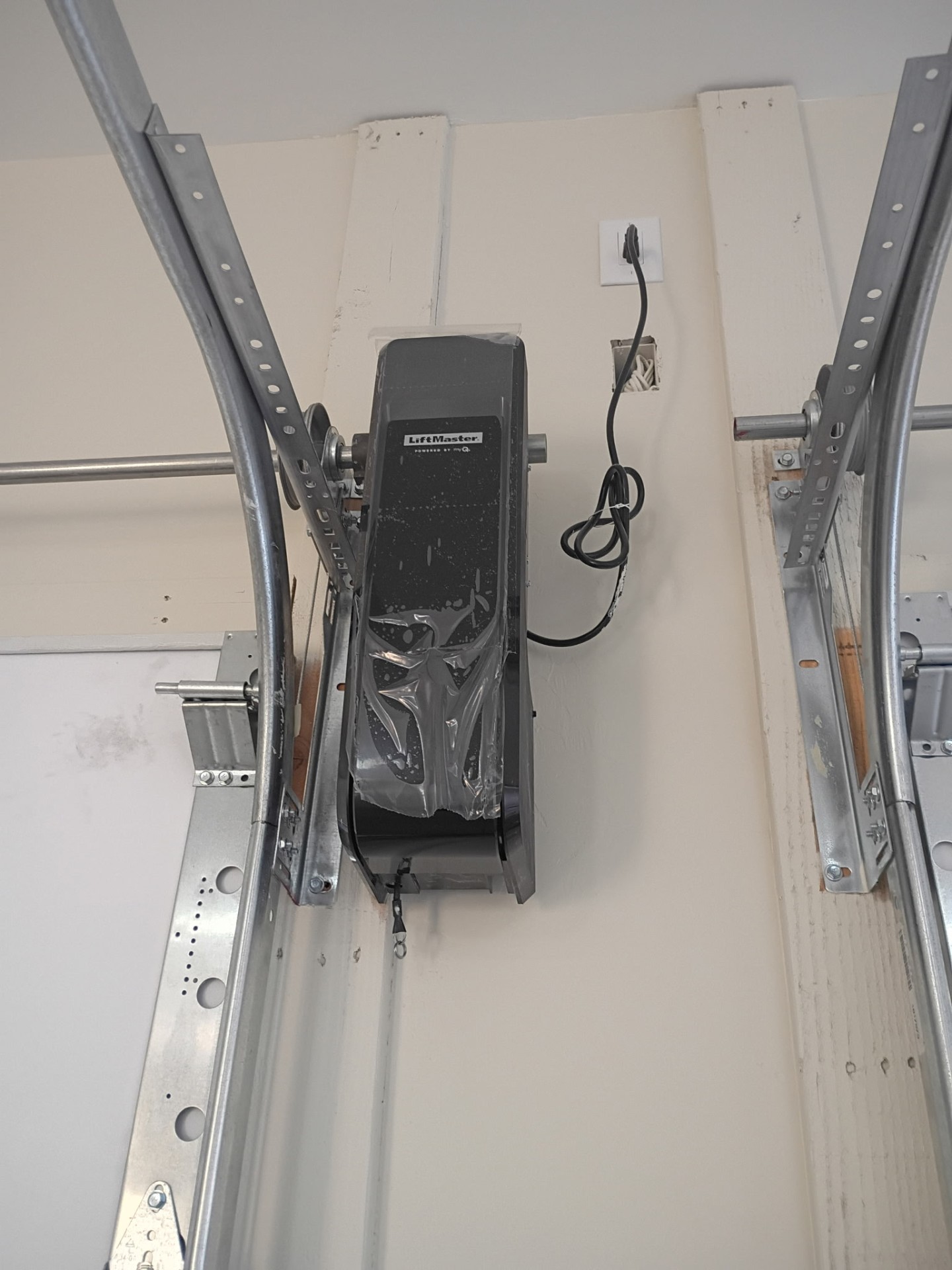 Close-up of a residential garage door opener and rail system